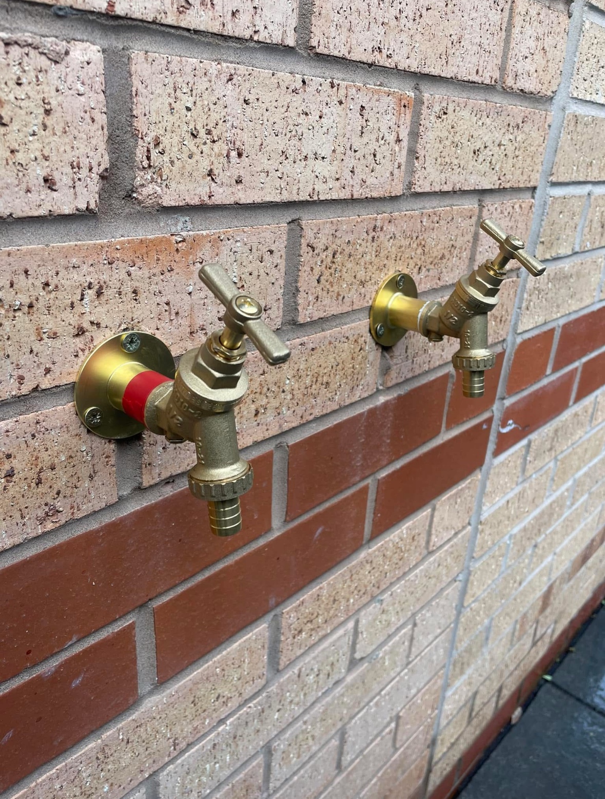 Outside tap installation on a brick wall — CM Plumbing & Heating, Buckley